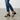 Billi Bi black leather sandals with double buckle straps and block heel, worn with cuffed blue denim jeans.