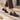Mocassins artisanaux Billi bi en cuir mogano avec semelle cousue, portés sur un trottoir par moodeshop