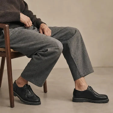 Derbie moc macho noir porté avec pantalon gris, style hipster casual urbain