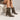 Femme portant la botte Vully 50 suède marron café, vue rapprochée des pieds en studio